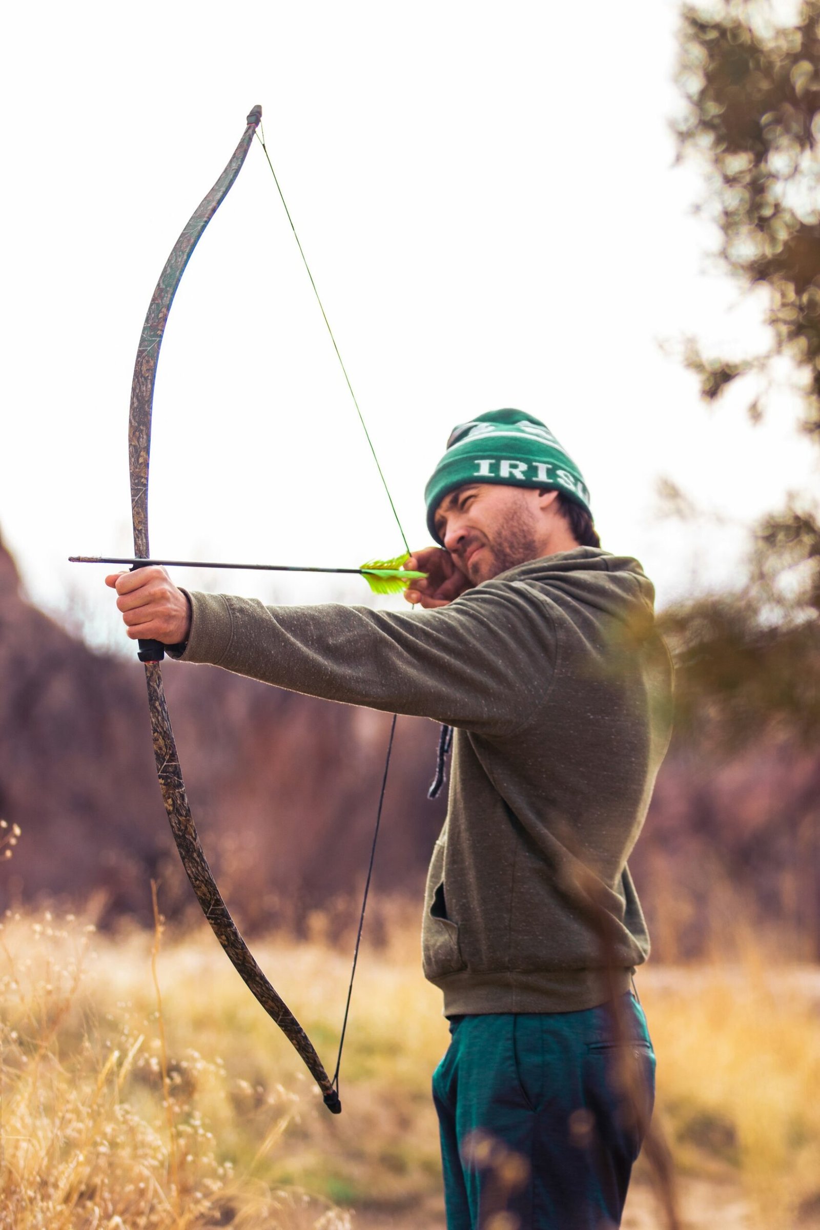 An archer drawing a bow toward a target
